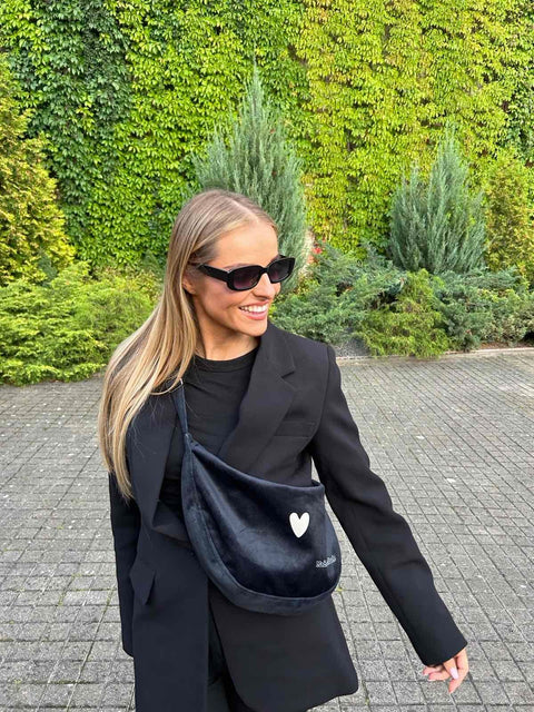 3. Garbanota Hobo Bag Heart in black with heart detail, held by hand in a studio setting