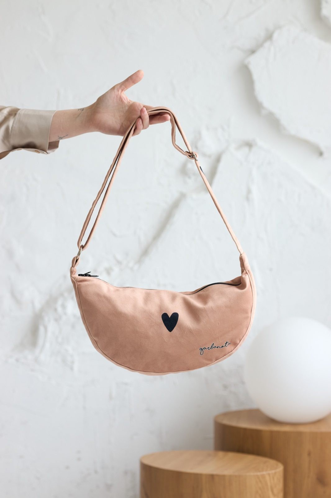 2. Garbanota Hobo Bag Heart in cream, shown in studio with adjustable strap and heart detail