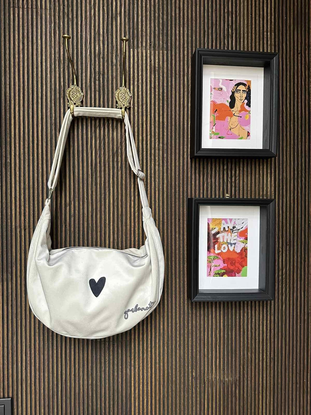 16. Garbanota Hobo Bag Heart in white against patterned background, highlighting heart design
