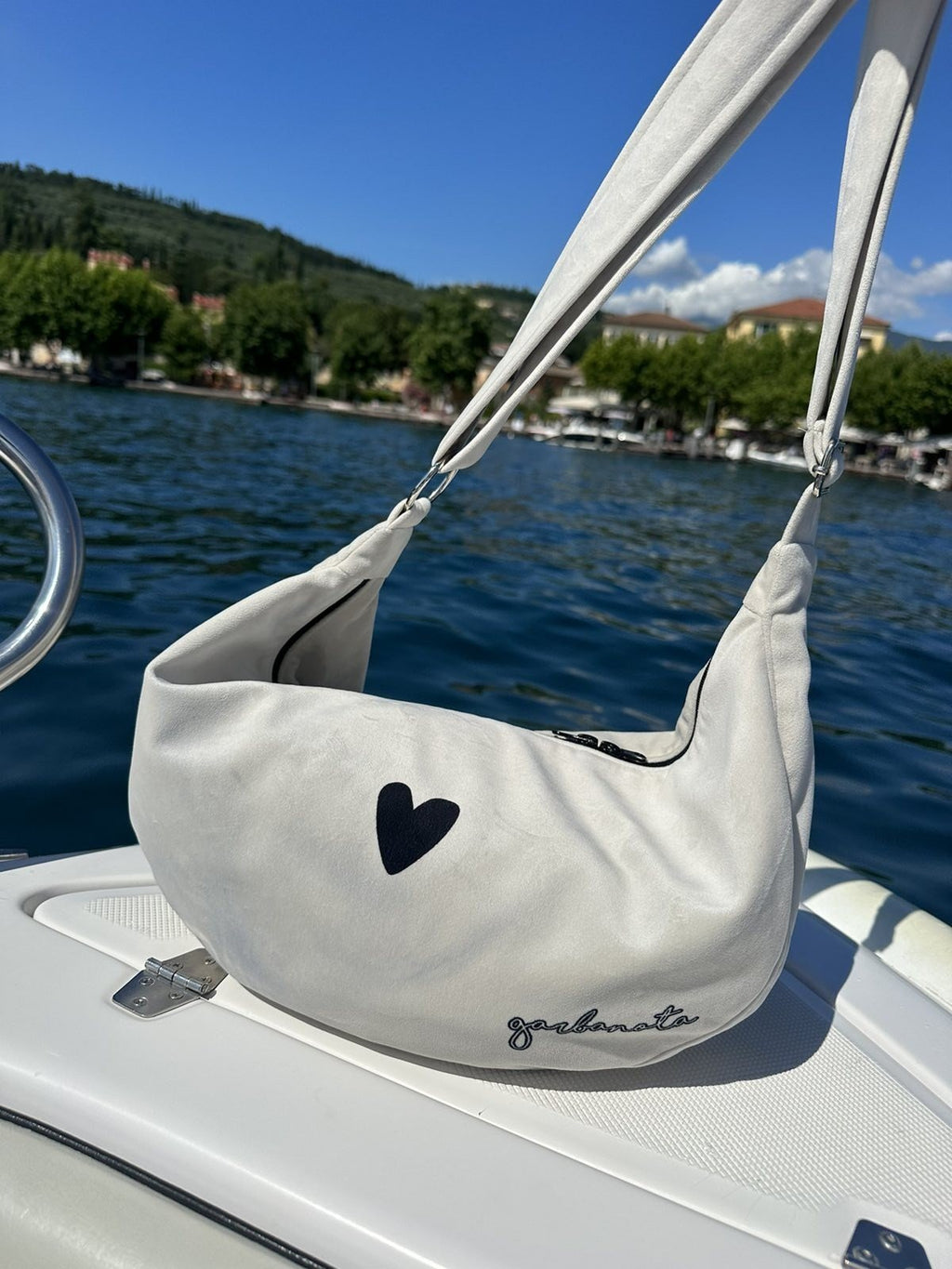 7. Close-up of Garbanota Hobo Bag Heart in white on boat, highlighting heart design and soft velour material