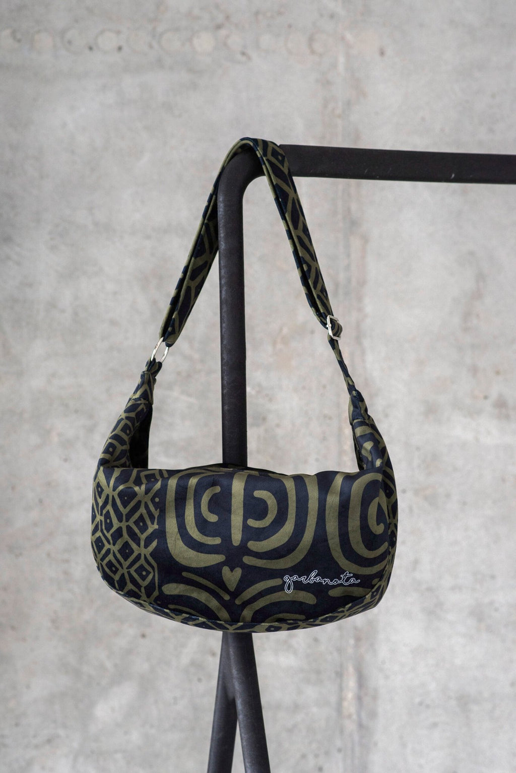 2. Studio shot of Garbanota Hobo Bag in khaki pattern, highlighting the soft velour material and brand logo