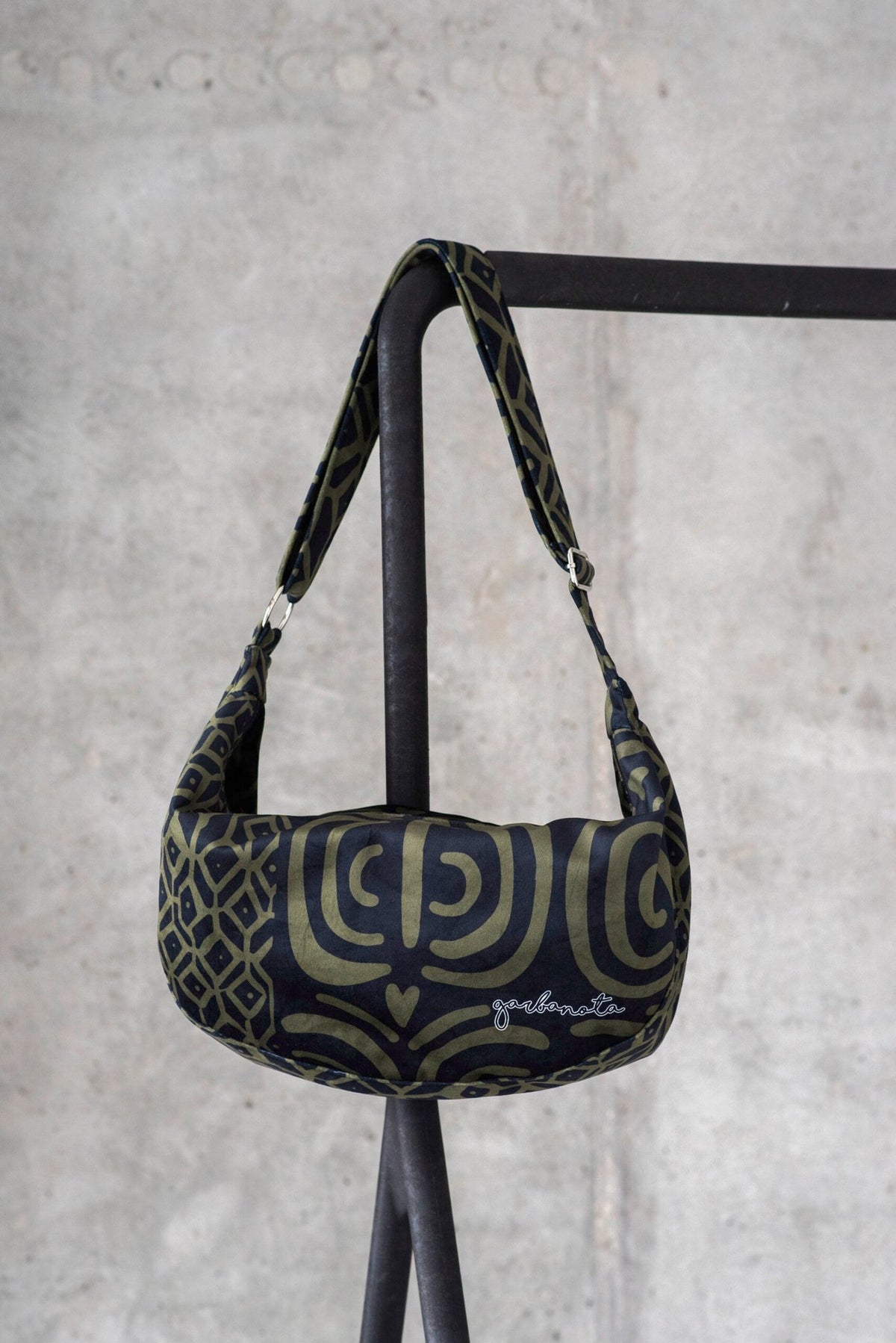 2. Studio shot of Garbanota Hobo Bag in khaki pattern, highlighting the soft velour material and brand logo