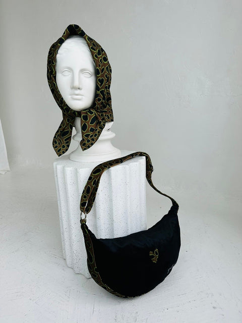 2. Garbanota Hobo Bag - Leopard Heart displayed with matching scarf on mannequin, highlighting artistic design