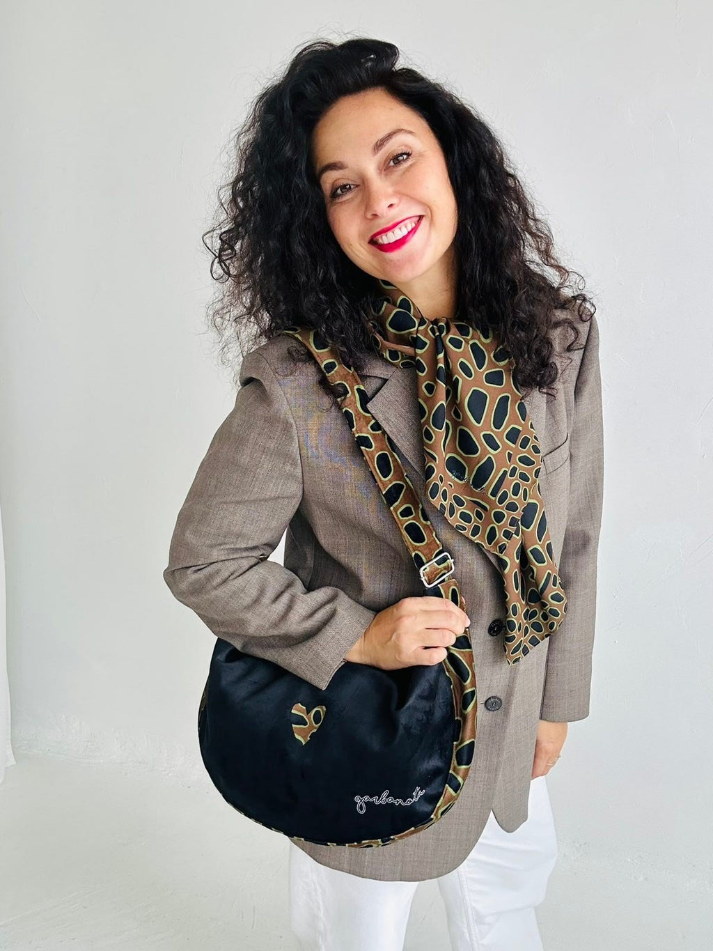 8. Woman wearing Garbanota Hobo Bag - Leopard Heart, demonstrating versatile wear and stylish look