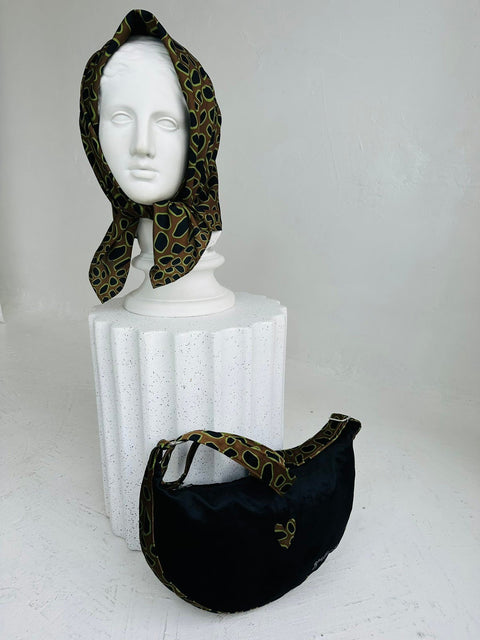 3. Side view of Garbanota Hobo Bag - Leopard Heart with matching scarf on mannequin, showing bag's shape