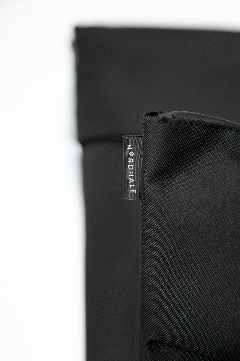 15. Close-up of Nordhale branding on HØLAR Weatherproof Backpack, emphasizing quality craftsmanship