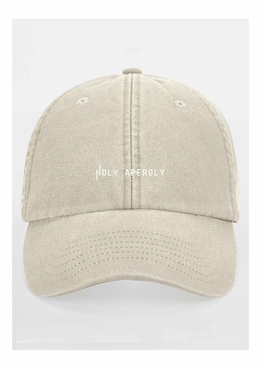 4. Studio shot of pastel beige Holy Aperoly cap by Black Giraffe Brand with white logo on front