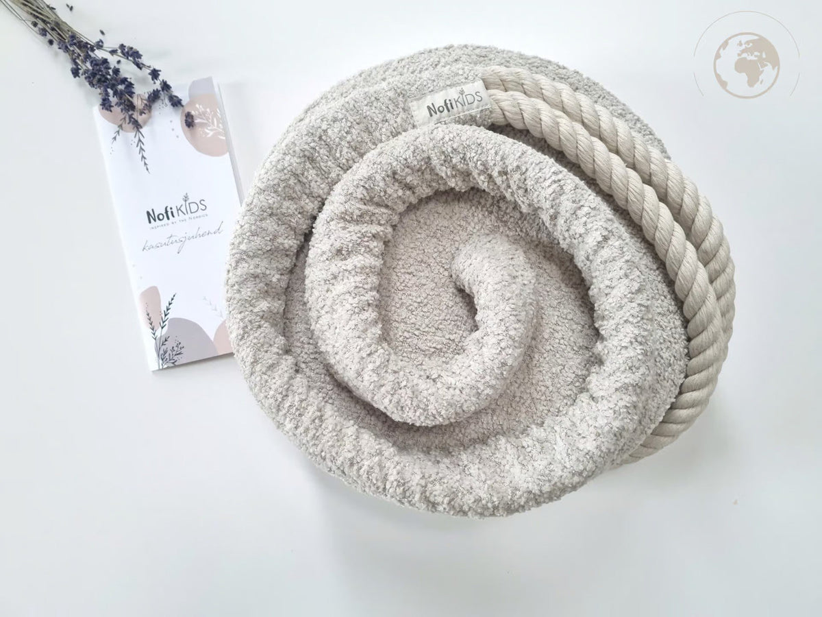 3. Rolled bouclé pearl white swing with Nofi KIDS tag and cotton rope on white background