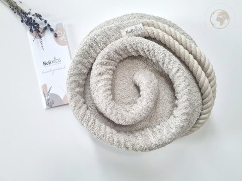 3. Rolled bouclé pearl white swing with Nofi KIDS tag and cotton rope on white background