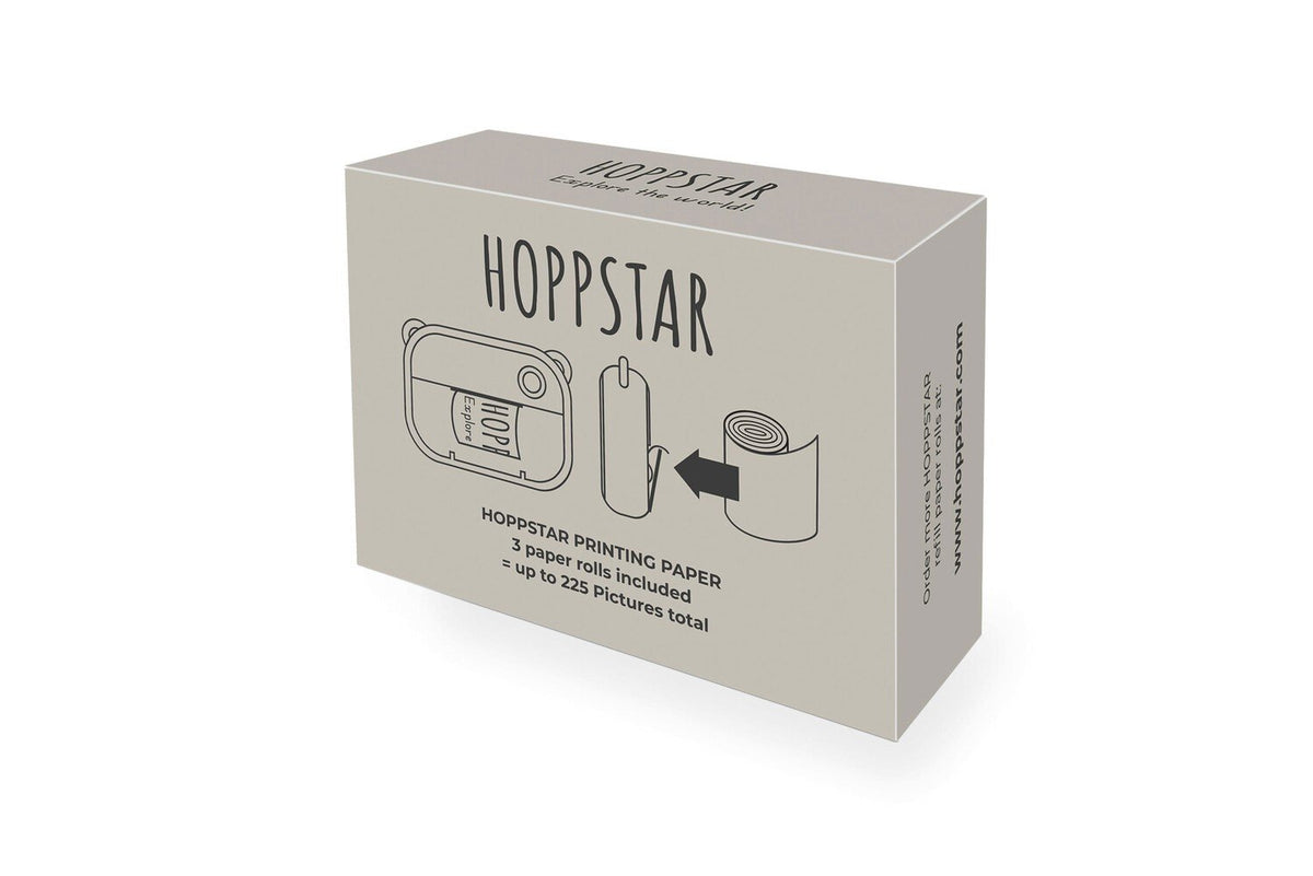 1. Box of Hoppstar thermal paper rolls for Artist camera, showing illustration of camera and paper roll, includes text '3 paper rolls included, up to 225 pictures total' on white background