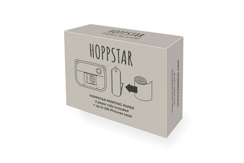 1. Box of Hoppstar thermal paper rolls for Artist camera, showing illustration of camera and paper roll, includes text '3 paper rolls included, up to 225 pictures total' on white background