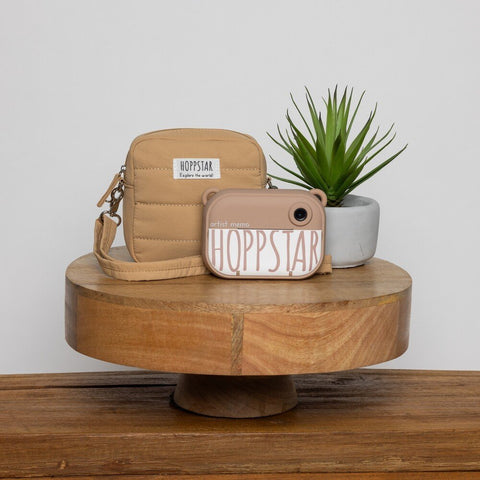 2. Hoppstar Artist Memo camera and carrying case on wooden stand with plant