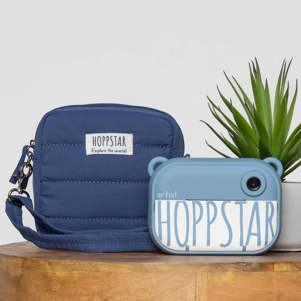 24. Navy Hoppstar camera bag with matching camera, placed on wooden surface
