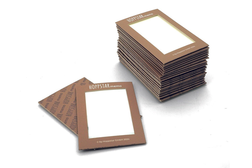3. Close-up of stacked Hoppstar Memory Game envelopes with logo on a white background