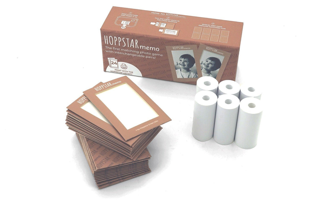 2. Hoppstar Memory Game set with brown envelopes and white paper rolls on a white background