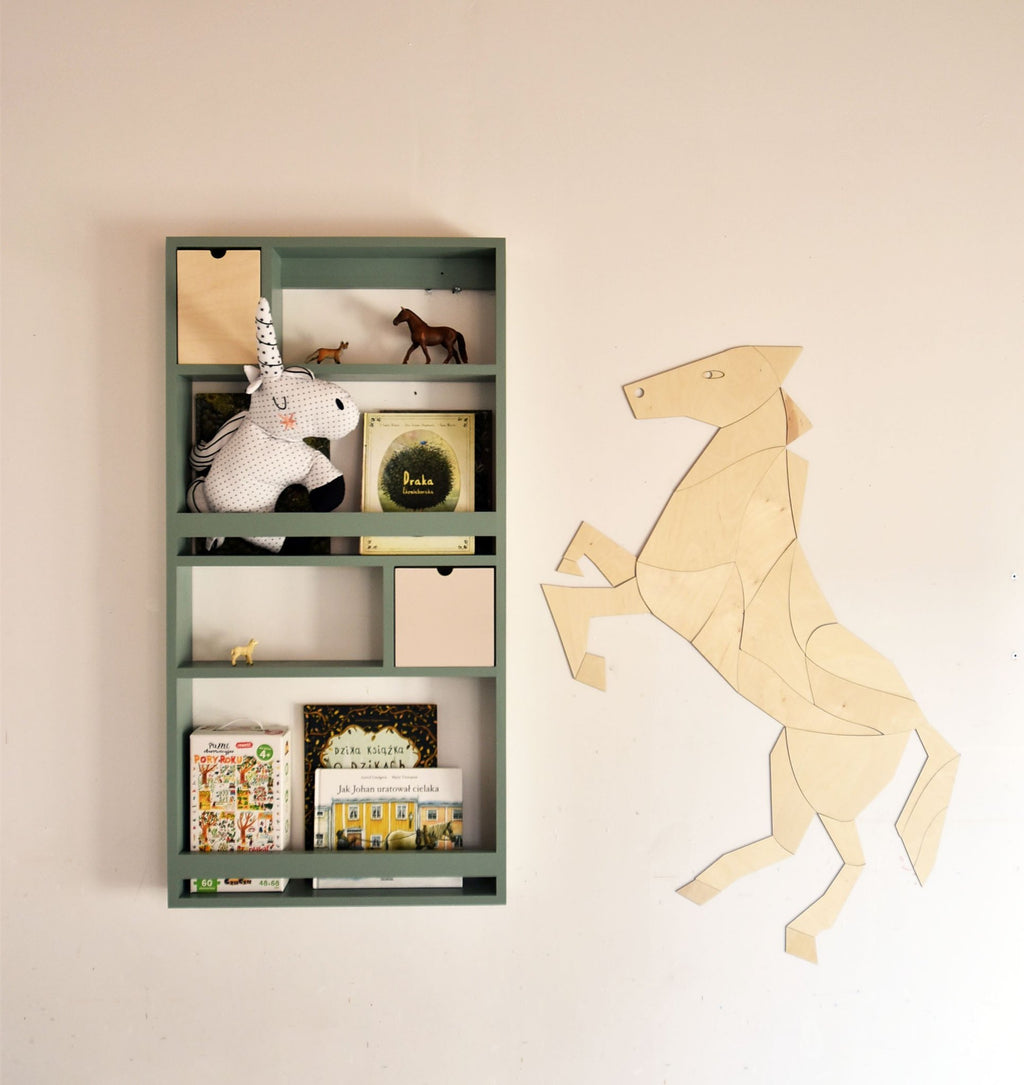 4. Wooden origami horse wall decoration next to a green shelf with children's books and toys