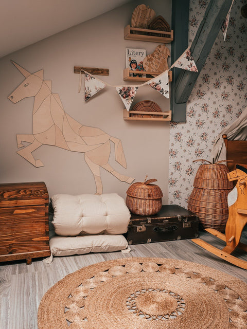 3. Wooden origami unicorn wall decoration in a cozy room with wicker baskets and floral wallpaper