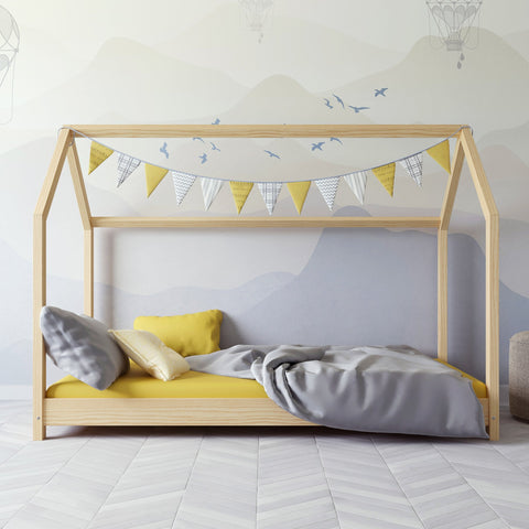 1. Kocot Kids Bella house bed in natural wood with yellow and grey bedding and bunting in a children's room