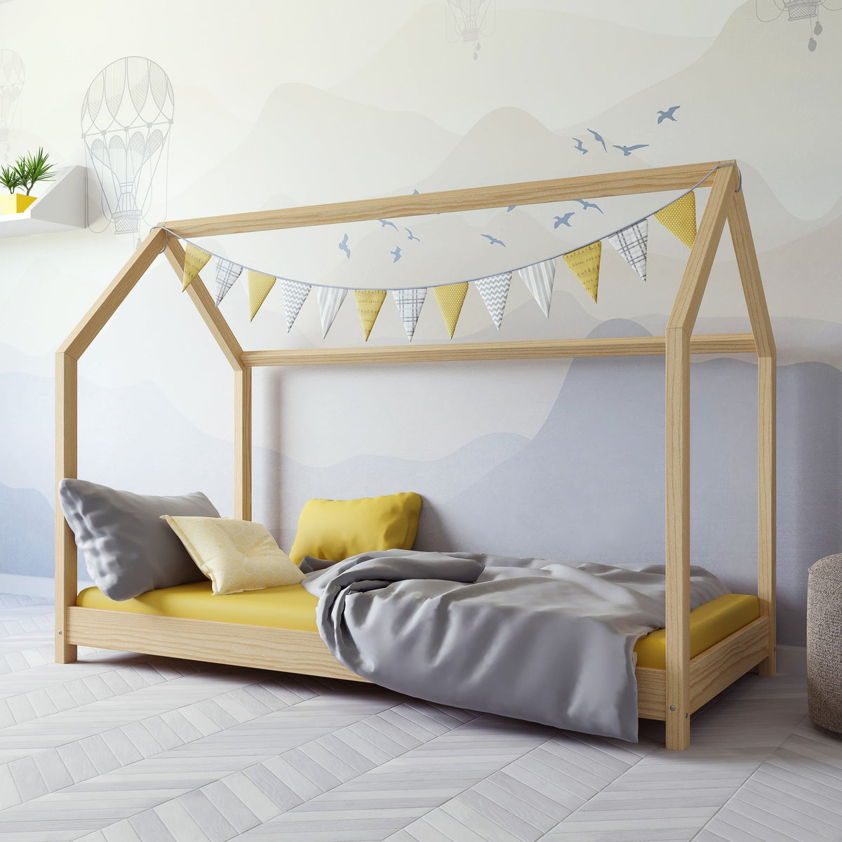 1. Children's room with Kocot Kids Bella house bed in natural wood, decorated with yellow and grey bedding and bunting
