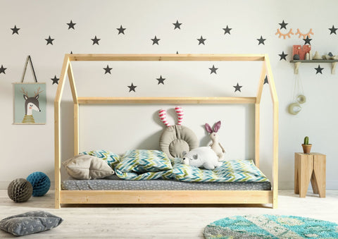1. Kocot Kids Bella house bed in natural wood with colorful bedding and plush toys in a star-themed children's room