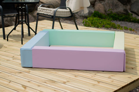 4. IGLU light pastel foam ball pit on wooden deck showing pastel color design