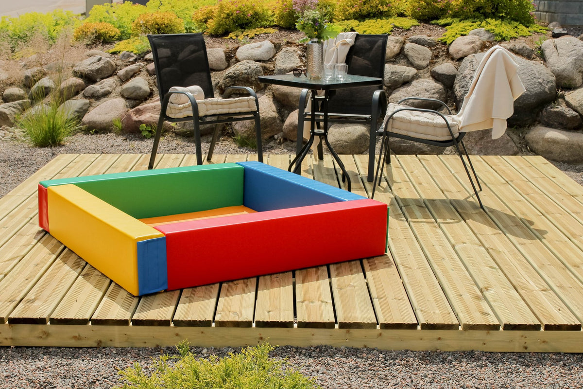 4. Multicolor IGLU soft play ball pit on a wooden deck with outdoor seating