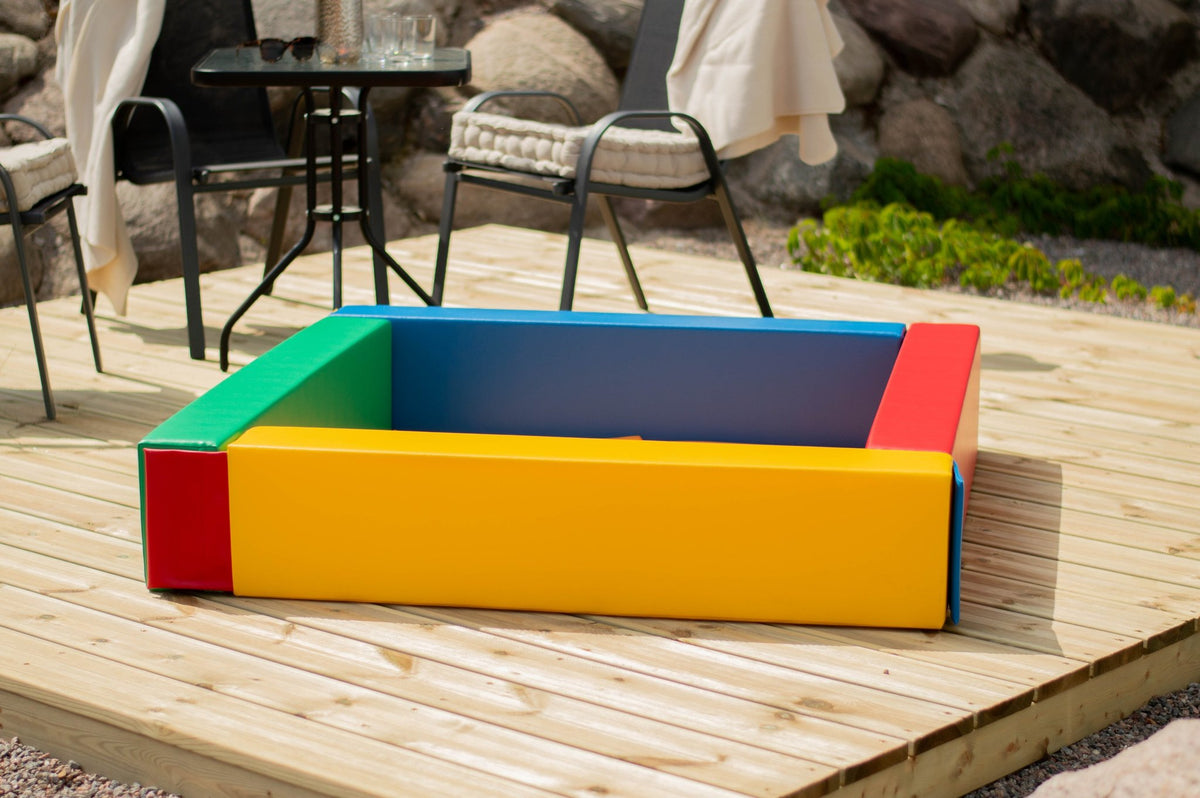 7. Multicolor IGLU soft play ball pit on a wooden deck in a garden setting