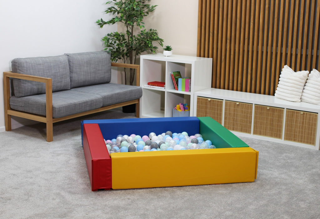2. Multicolor IGLU soft play ball pit in a modern living room setting with pastel balls