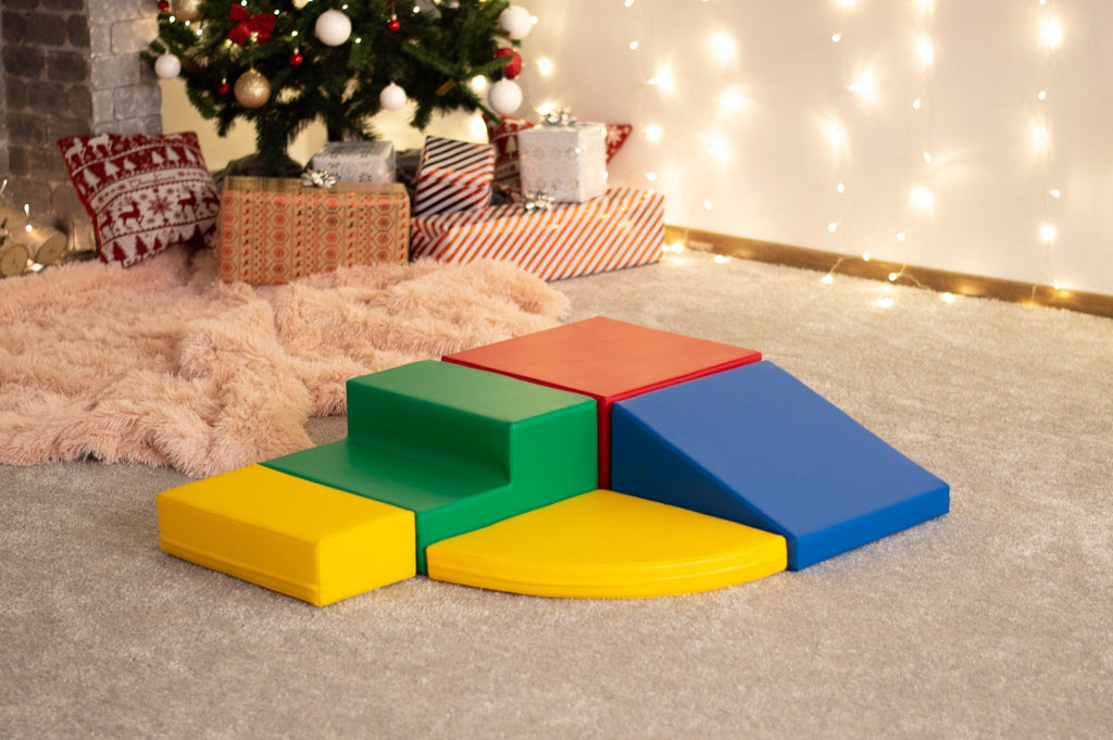4. Multi-color foam block set arranged in a corner climber configuration in a festive indoor setting with holiday decor