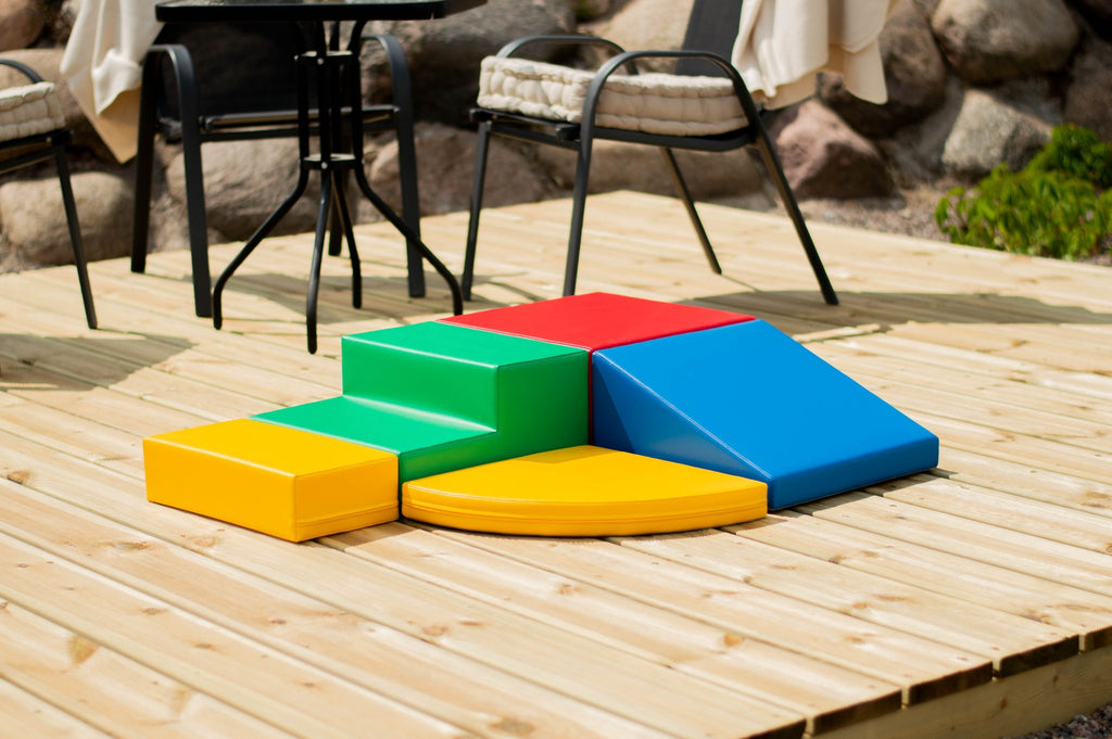 9. Multi-color foam block set arranged on a wooden deck with outdoor furniture and natural background