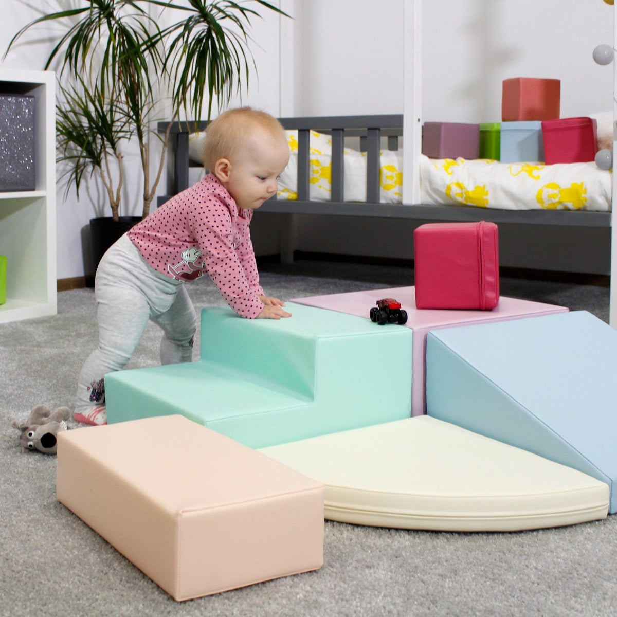 4. Child exploring IGLU pastel foam blocks in a bedroom, encouraging physical activity and social skills