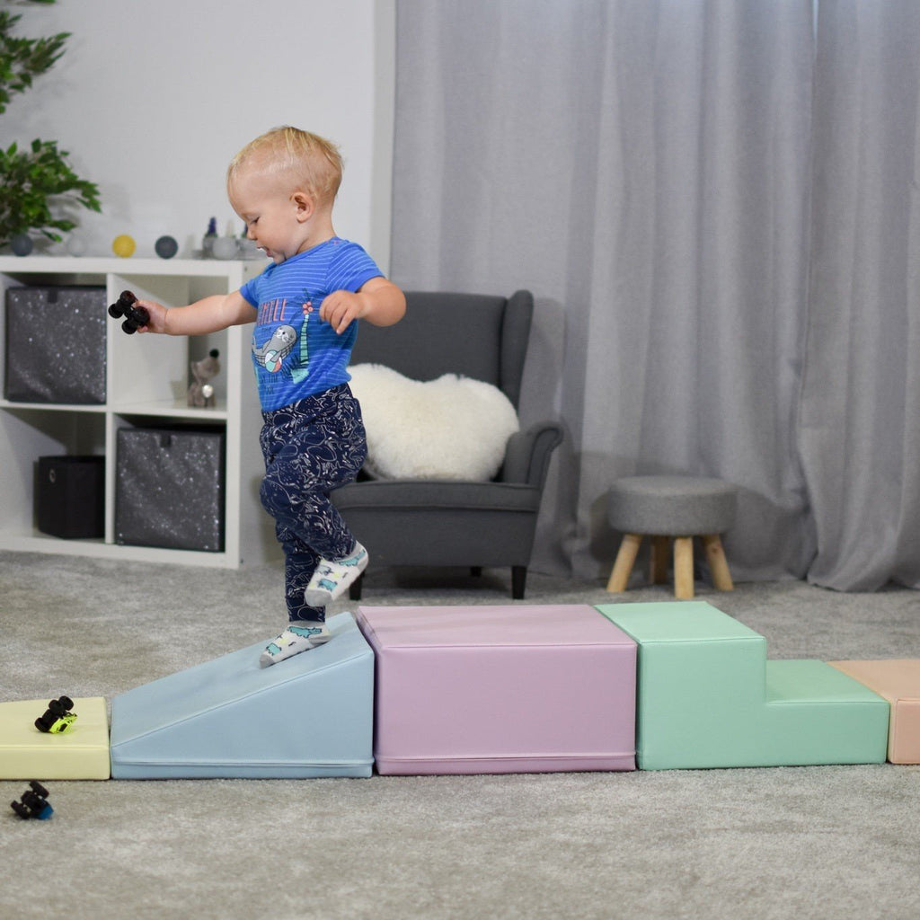 10. Child balancing on IGLU pastel foam blocks in a living room, enhancing coordination and strength