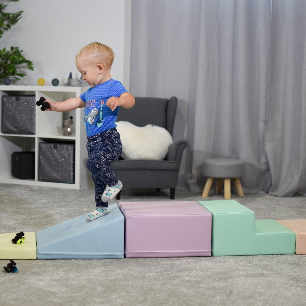 10. Child balancing on IGLU pastel foam blocks in a living room, enhancing coordination and strength