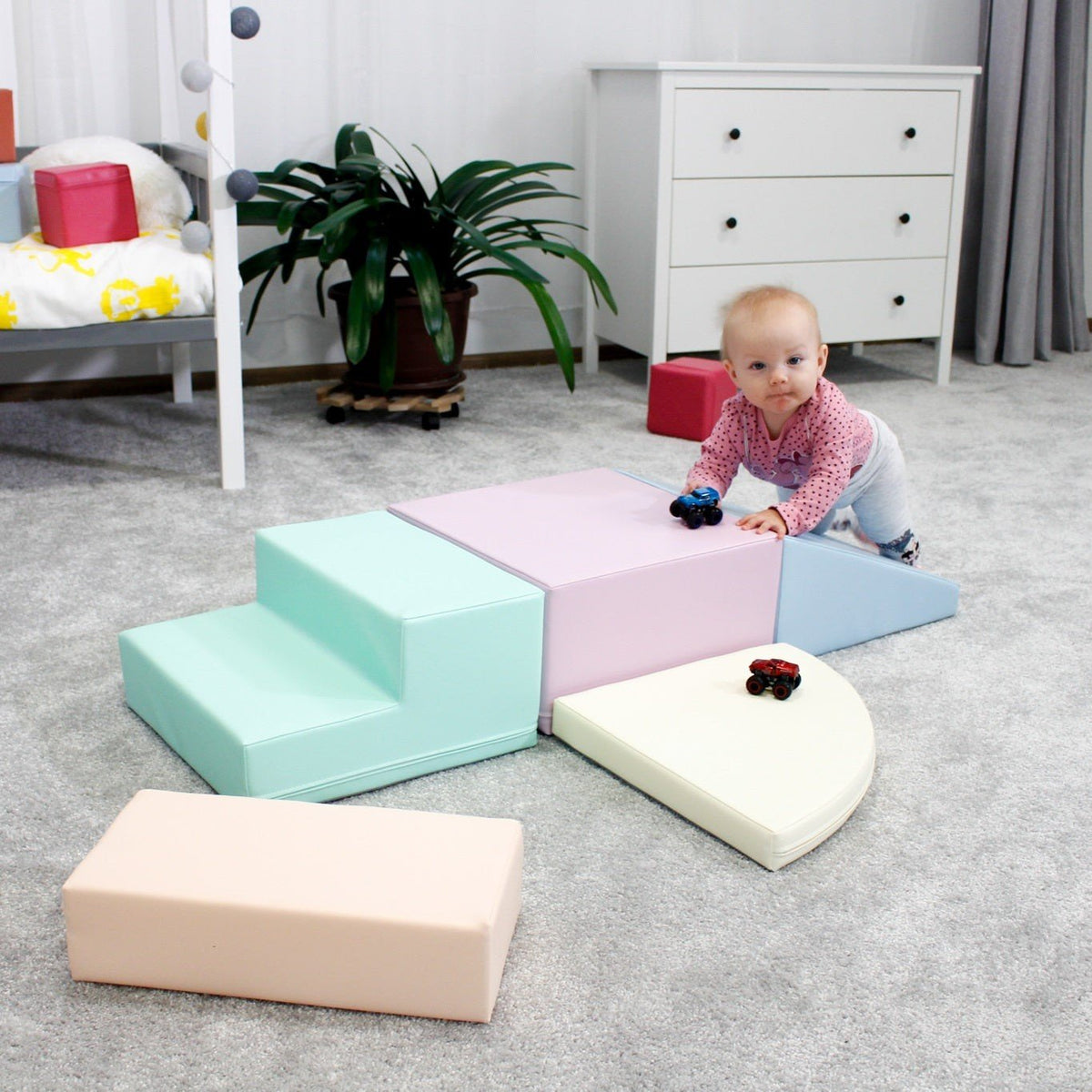 17. Baby playing on IGLU pastel foam blocks in a playroom, enhancing motor skills and creativity