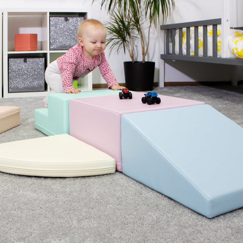 3. Toddler climbing on IGLU pastel foam blocks in a playroom, enhancing balance and coordination