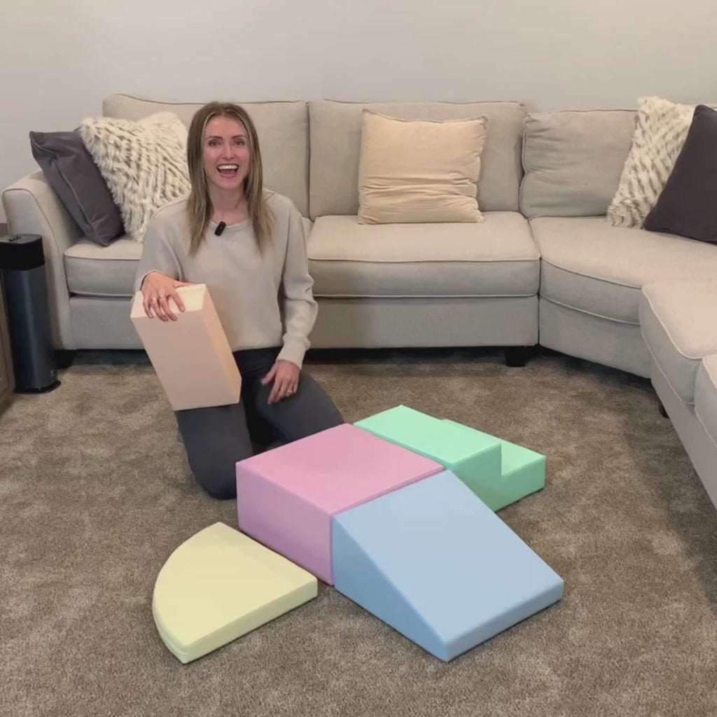 20. Woman demonstrating IGLU pastel foam block set in a living room, highlighting versatility and design
