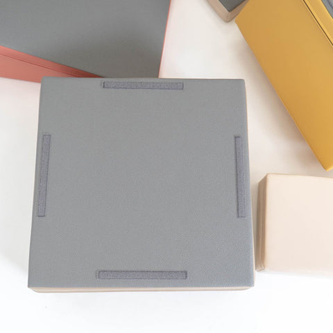 3. Close-up of grey foam block with non-skid bottom and beige and yellow blocks in background