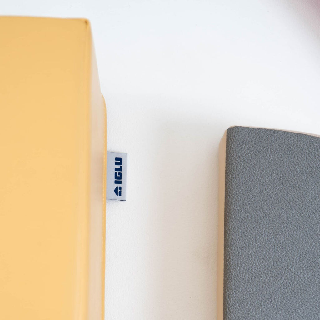 10. Close-up of IGLU logo tag on yellow foam block next to grey block