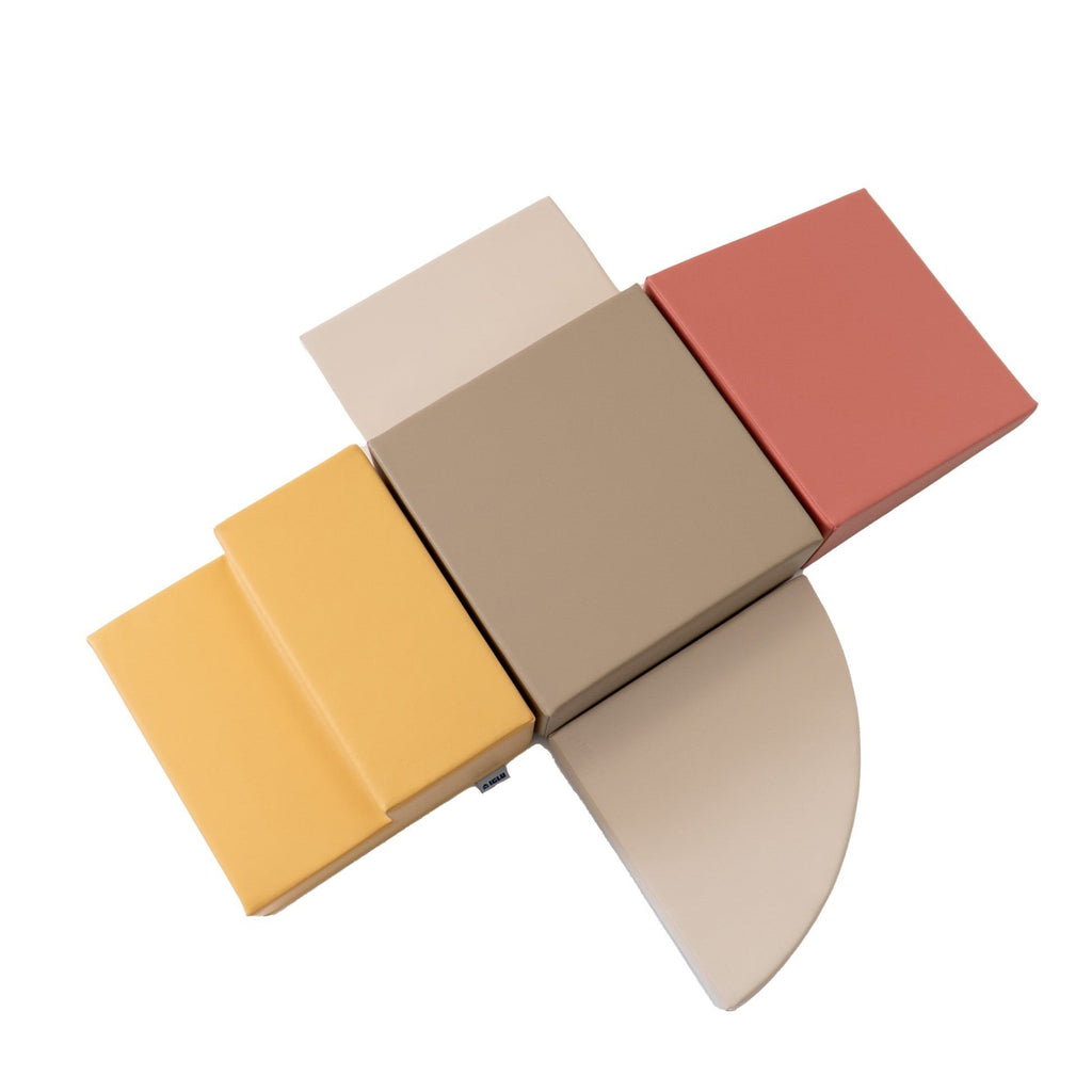 8. Top view of pastel pink and beige foam blocks arranged in an open configuration
