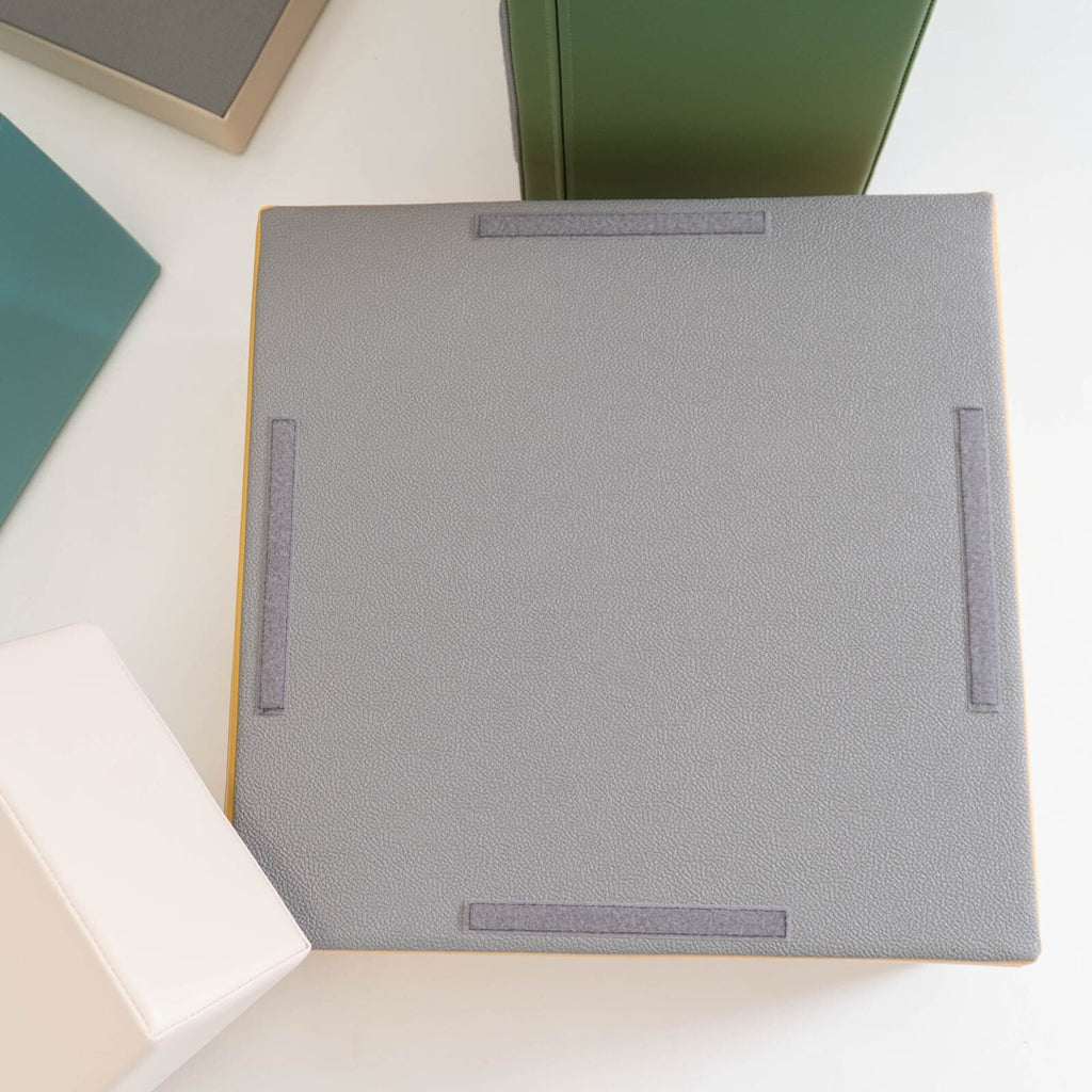 7. Close-up of IGLU foam block with non-skid bottom in grey, surrounded by other blocks