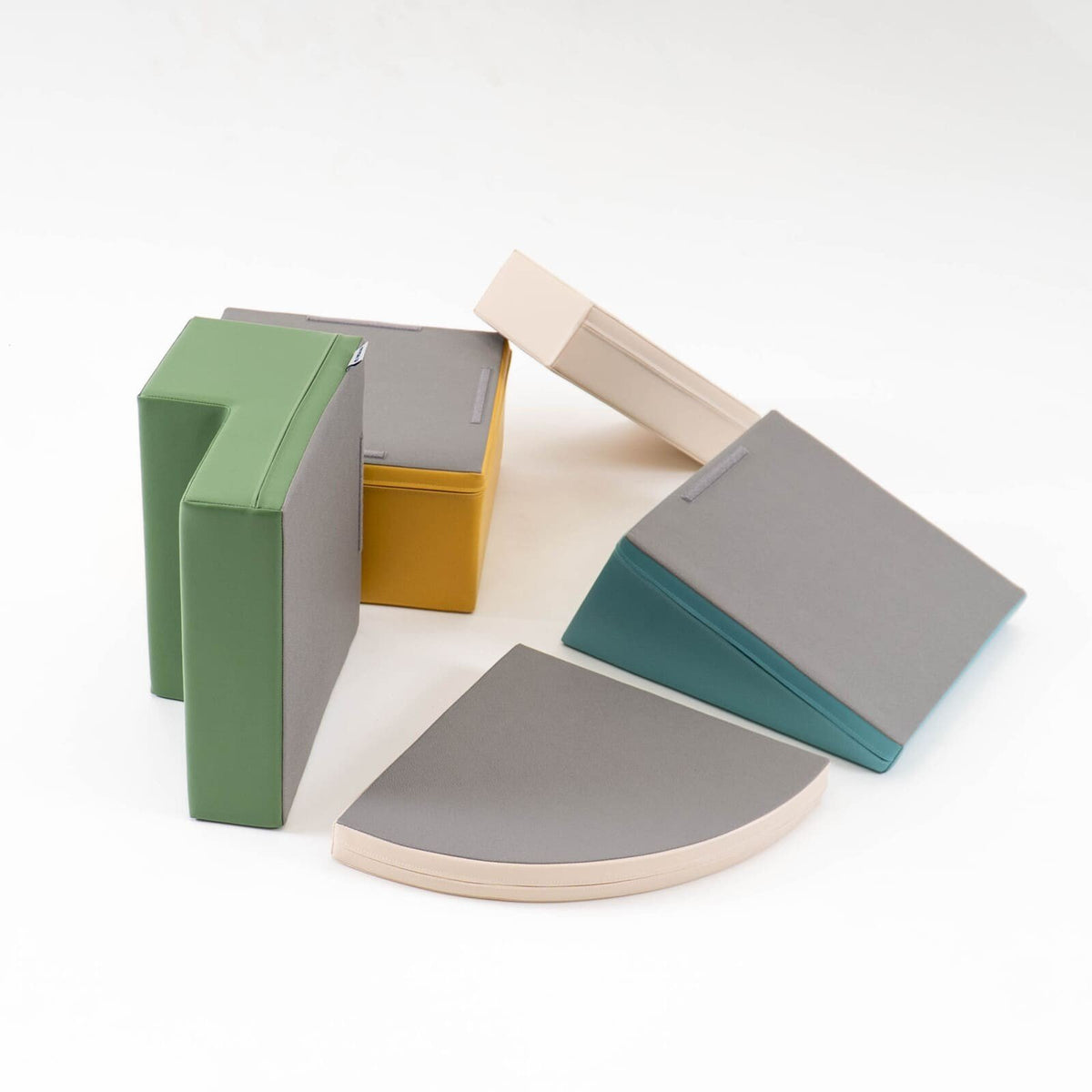 9. Flat lay of IGLU Corner Climber foam blocks in pastel colors showing bottom surfaces