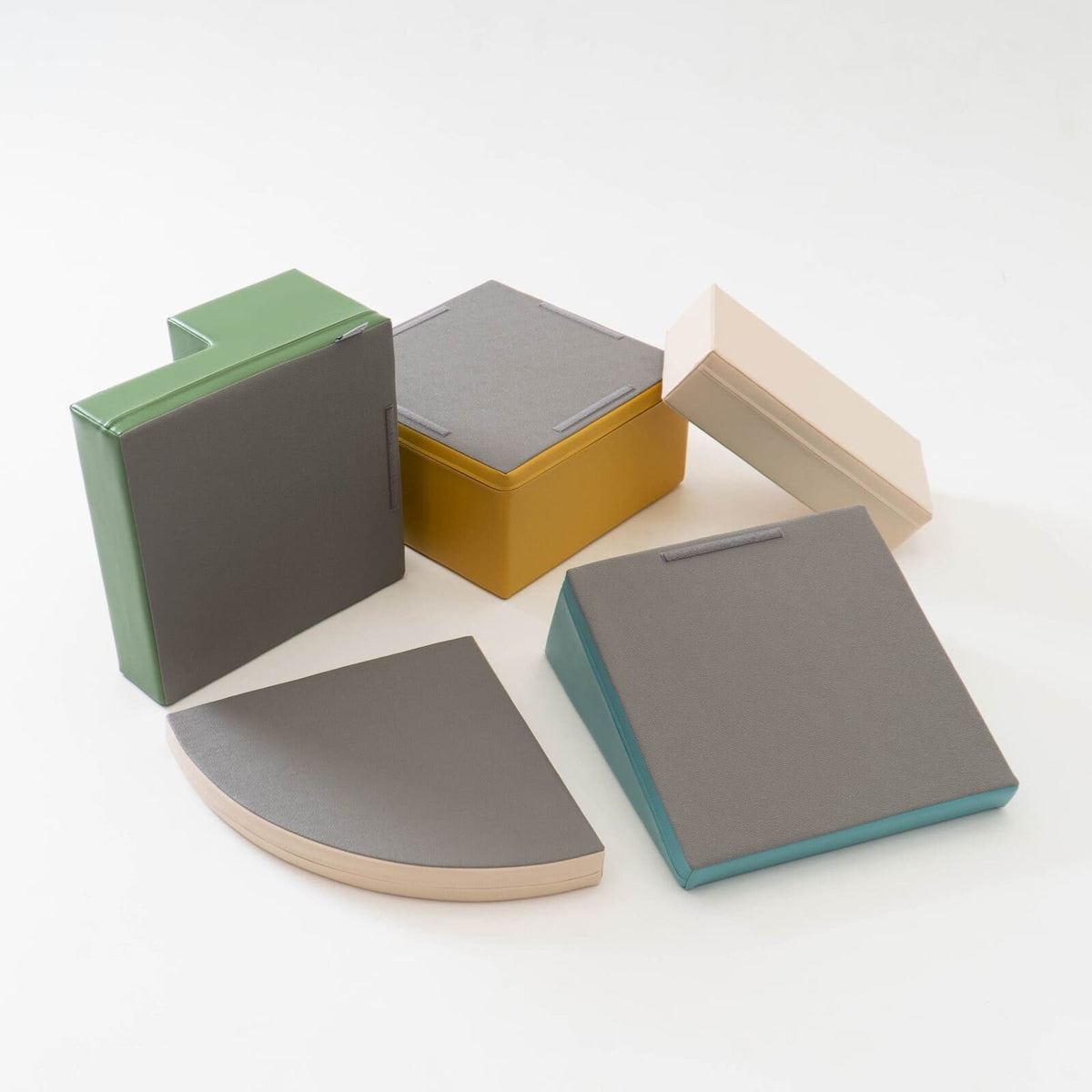 6. Flat lay of IGLU Corner Climber foam blocks showing bottom surfaces in pastel colors