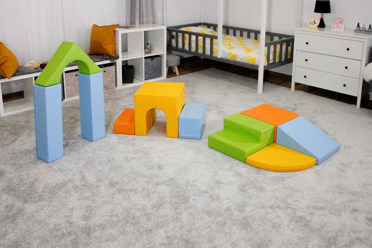 6. IGLU foam block set in light multicolor arranged in a child's bedroom with grey carpet