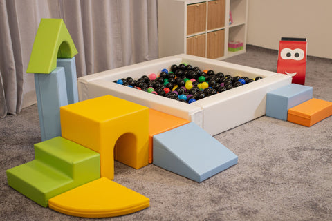 4. IGLU foam blocks in light multicolor arranged around a ball pit in a playroom