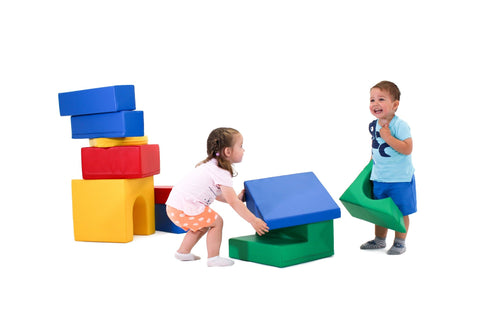 2. Two children playing with multicolor foam blocks, stacking and arranging them