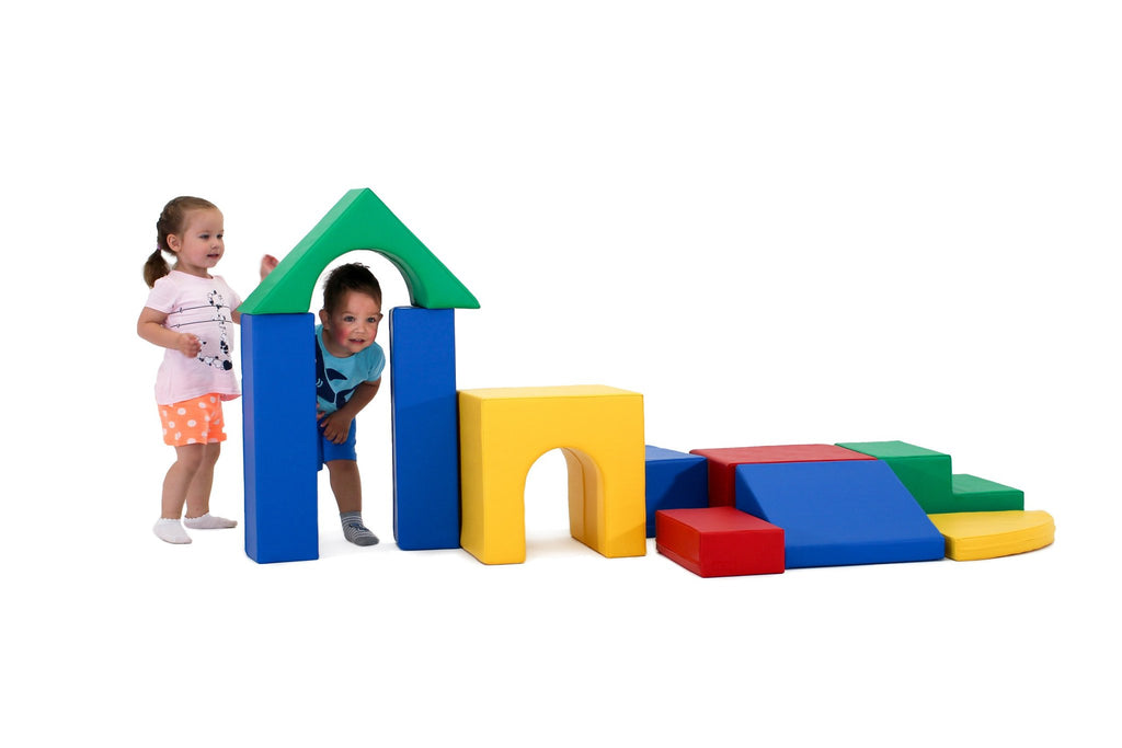17. Two children playing with multicolor foam blocks, one peeking through archway