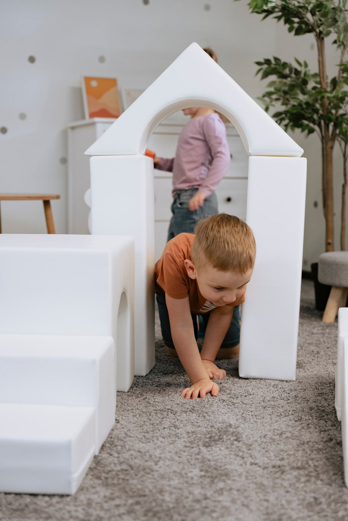 1. Two children interacting with white foam blocks in a playroom, part of IGLU Adventurer set