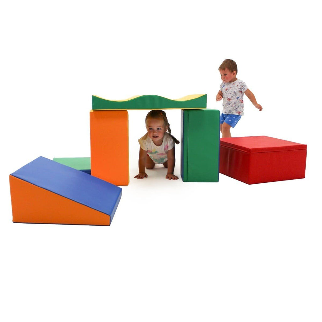 1. Two children playing with multicolor foam blocks in a playroom