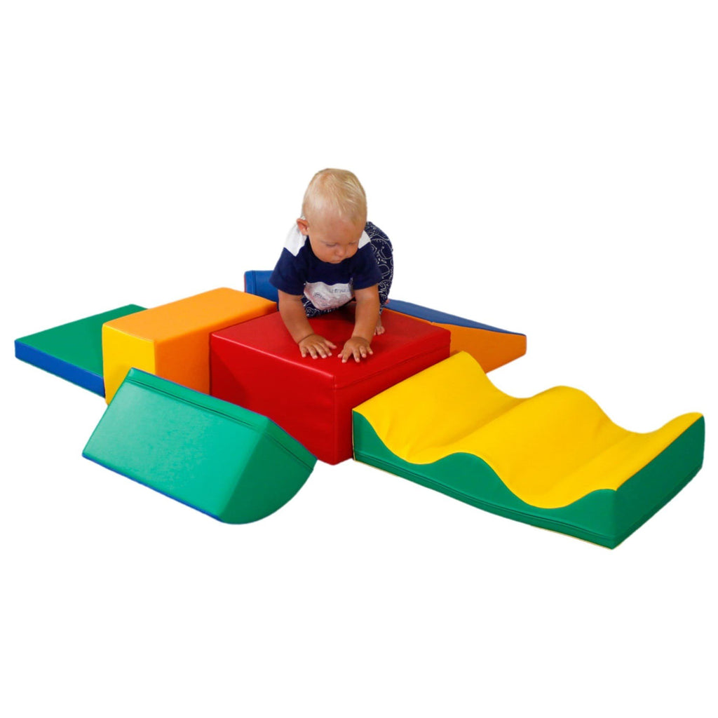 1. Child climbing on multicolor foam blocks in a playroom setting