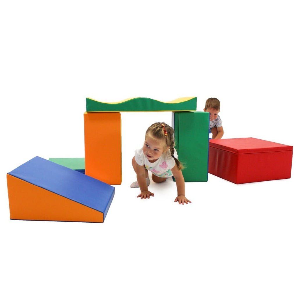 1. Two children crawling through multicolor foam blocks in a playroom